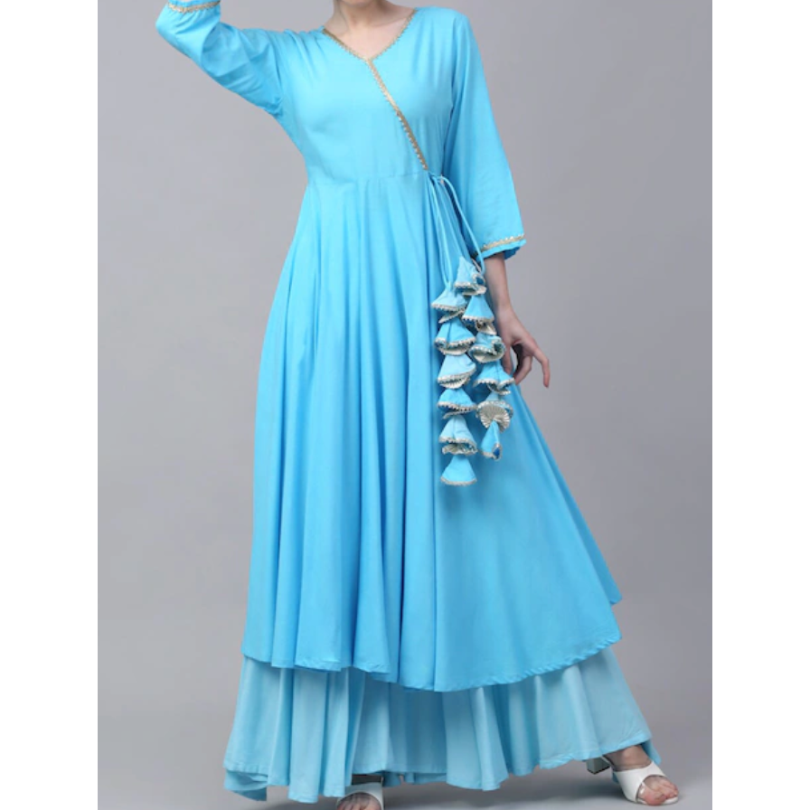 Soft blue angarakha style kurta set with amazing details on the tassels. Delicate gotta patti work on the neckline and sleeves. The matching sharara pants has a lovely flair to it. Perfect to wear it to dandiya /navaratri.  